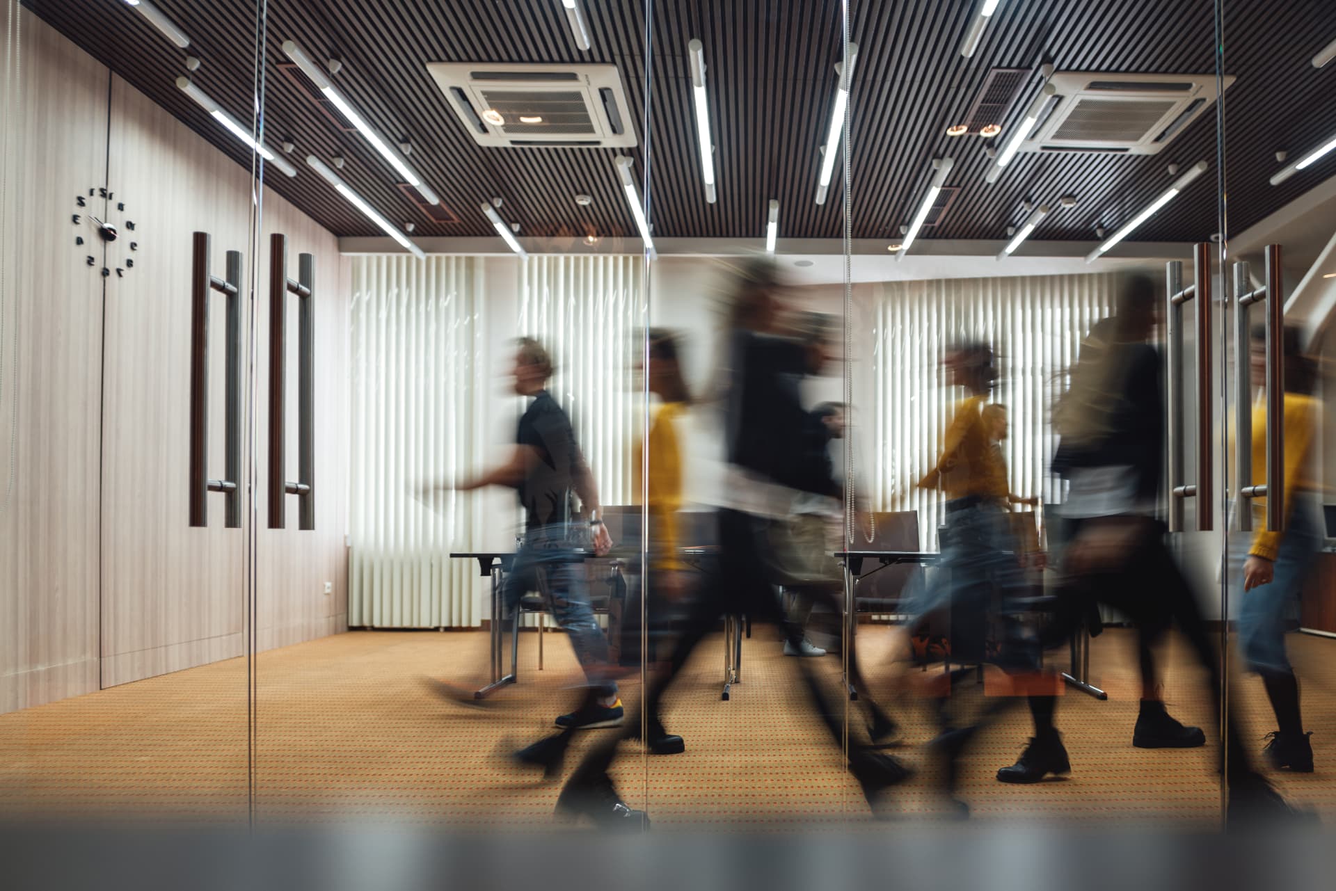 Advisory team moving between meetings in a busy office