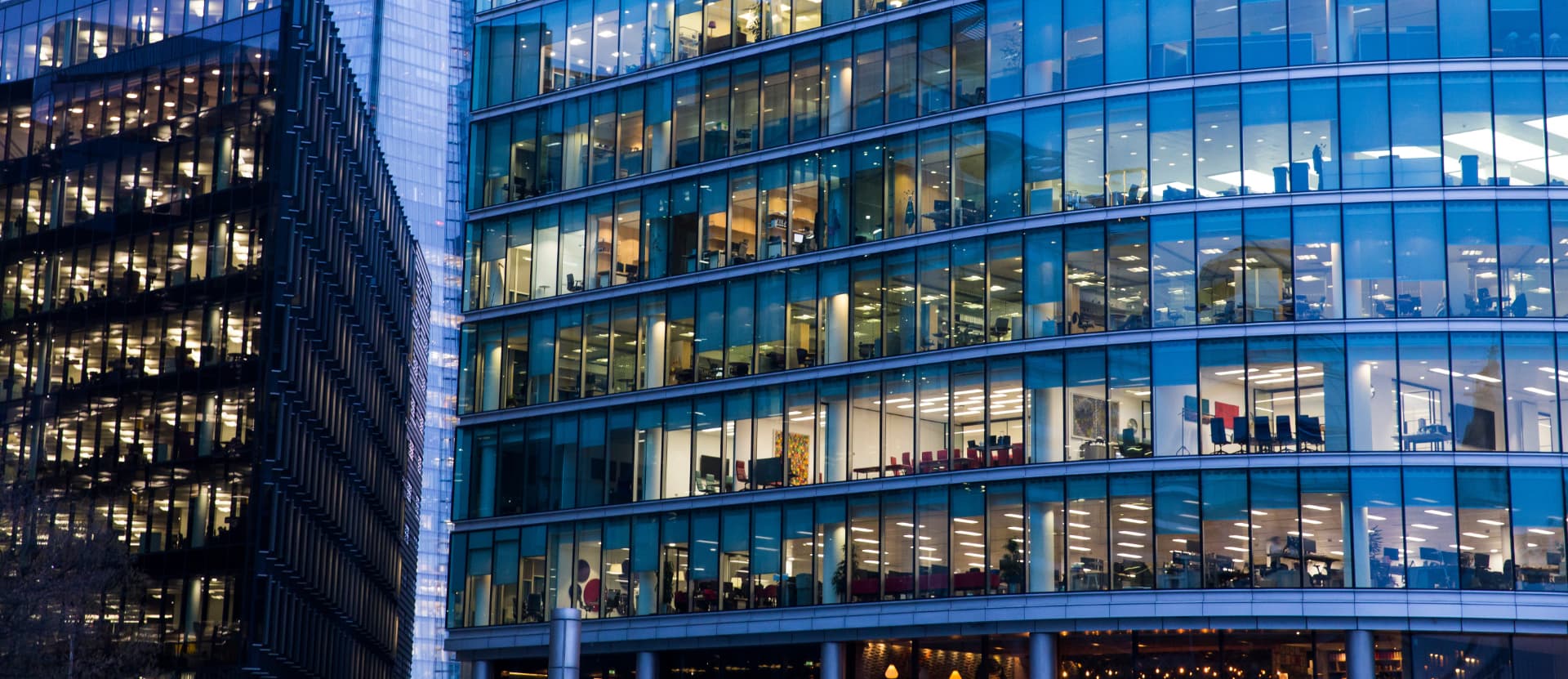 Modern glass office buildings illuminated at dusk